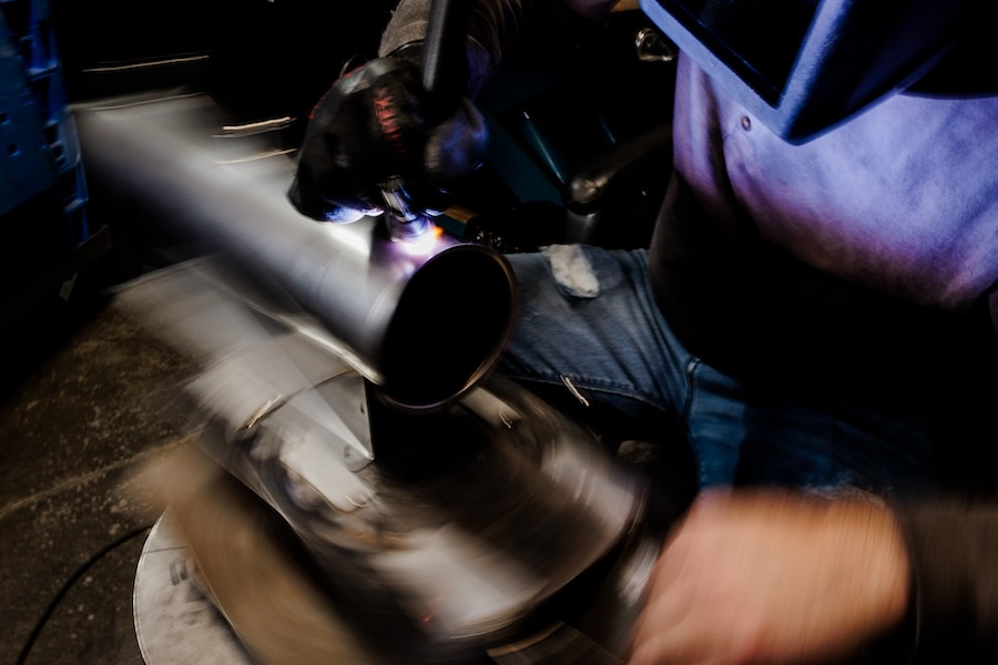 Another photo of a welder welding a custom tank.